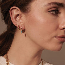 Load image into Gallery viewer, Huggie with Hanging Blue Topaz Baguette in Gold by Murkani