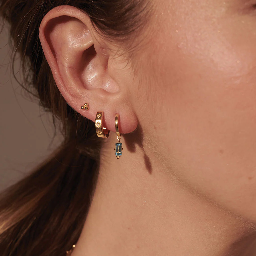 Huggie with Hanging Blue Topaz Baguette in Gold by Murkani